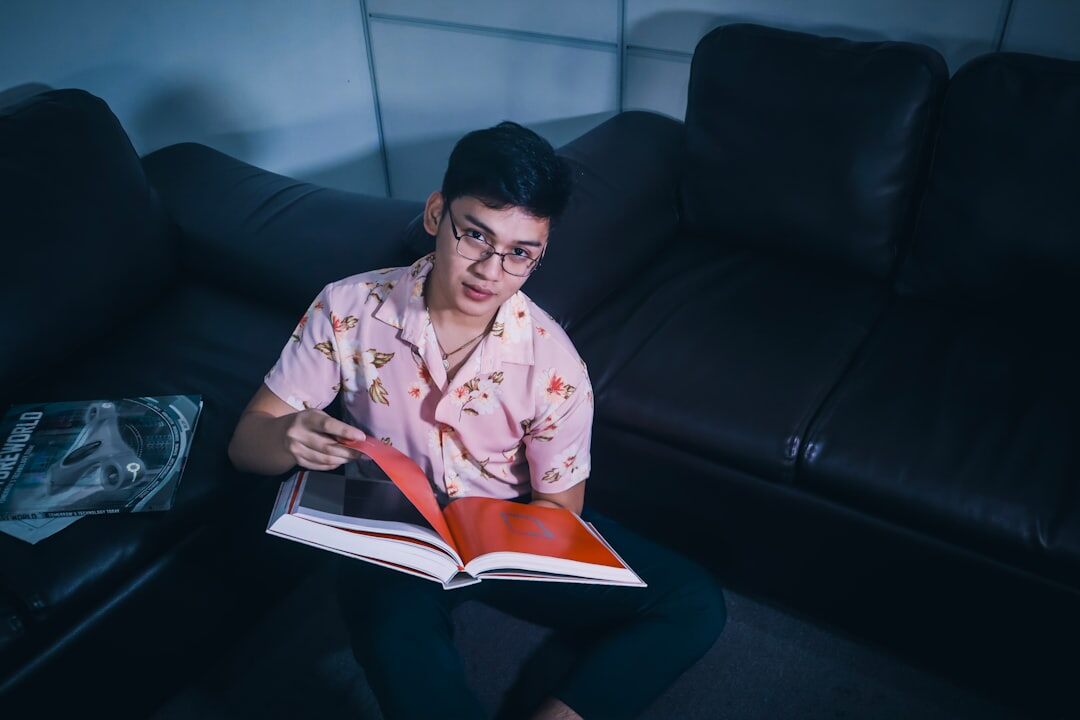 woman reading book at night