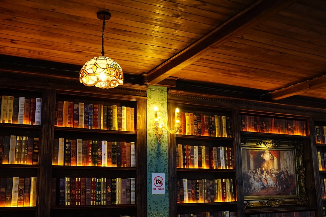 Grand old library reading room with tall bookshelves and warm lighting