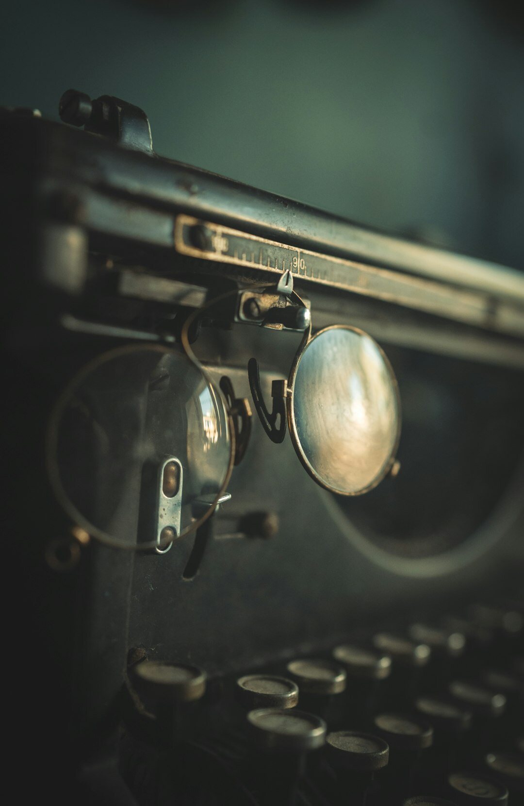Vintage typewriter with a magnifying glass and coffee cup on a wooden desk