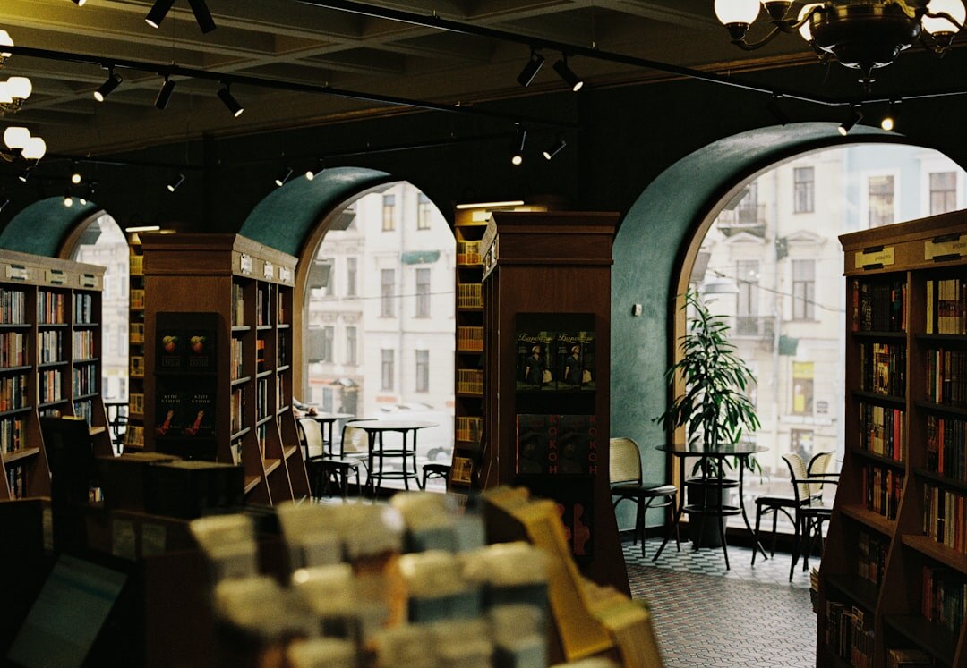 Cozy old bookshop interior filled with tall wooden shelves of books